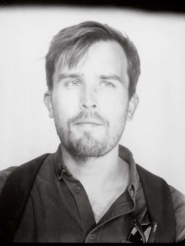 Black and white passport-style photo of Sam Baldwin